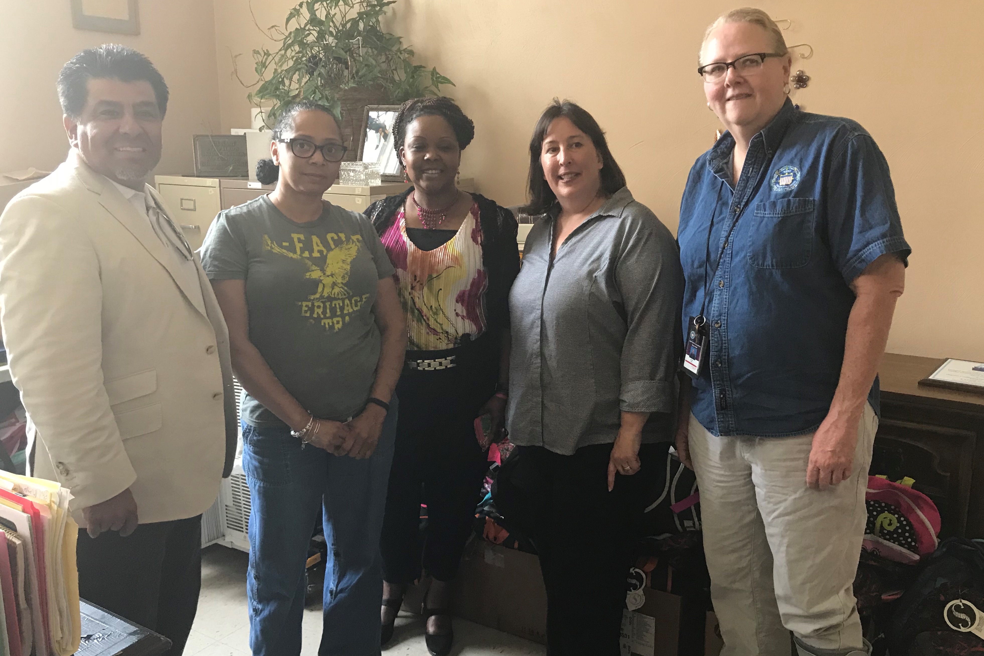Dr. Johnny Garcia and SimIS and JT&E employees with Wesley Community Center staff after dropping off backpacks and supplies.